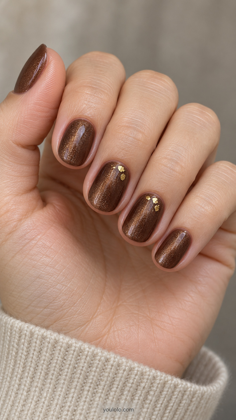Short round nails: soft chestnut brown magnetic velvet nails with a few very small irregular flat gold foil flecks near cuticle on ring and middle only.