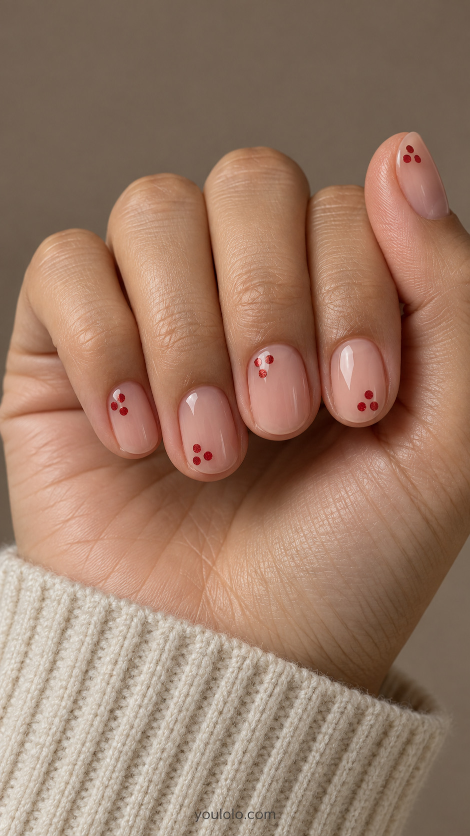 Short nude oval nails with tiny red glitter dot clusters