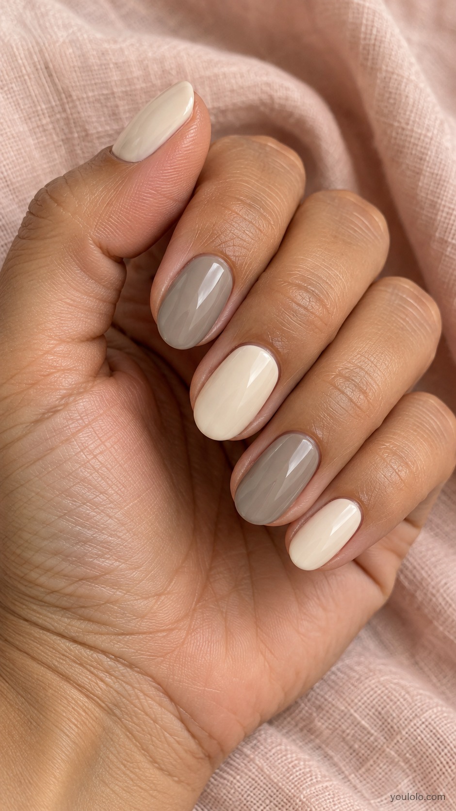 Medium oval nails alternating warm cream and neutral stone gray opaque gloss