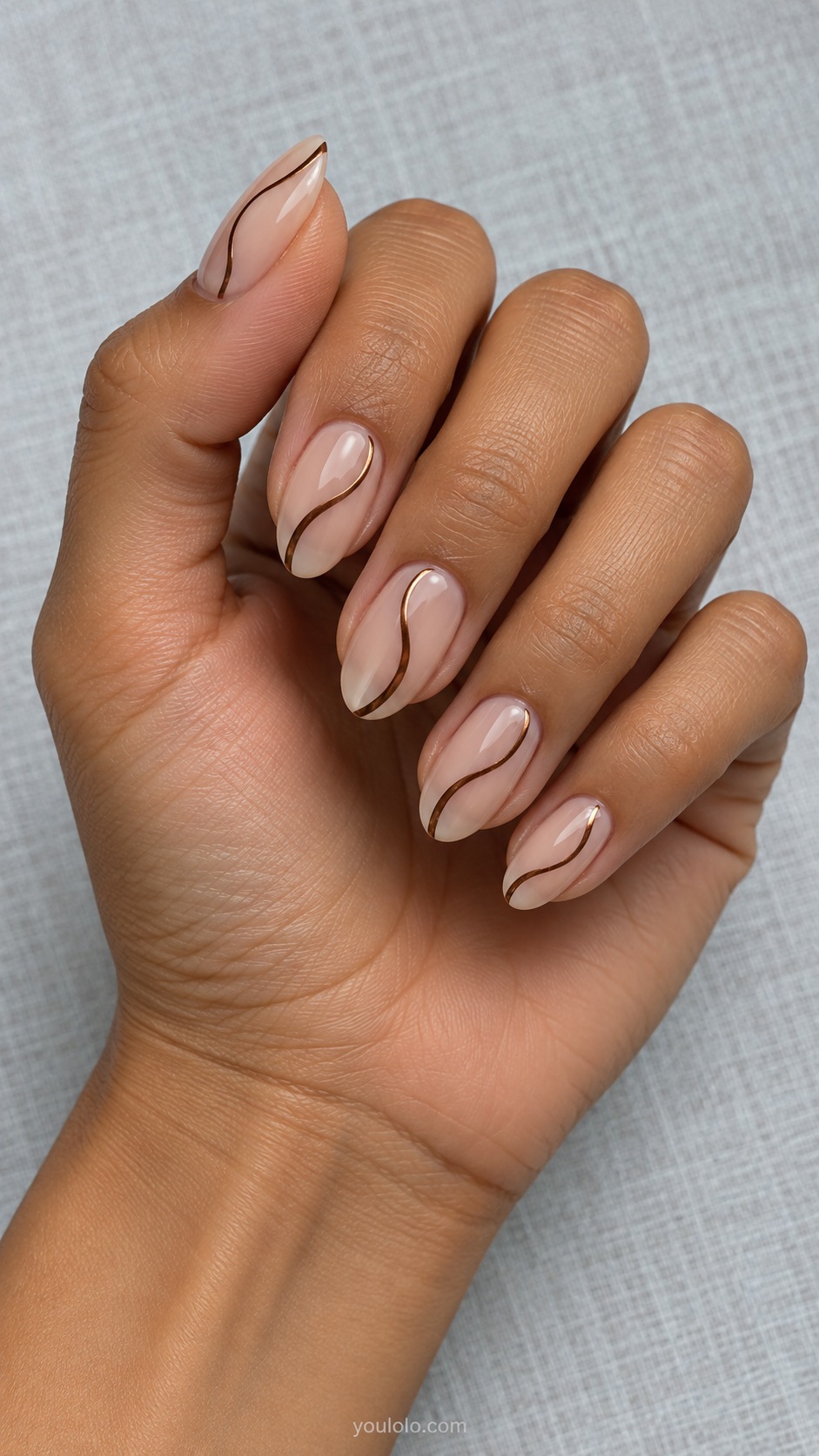 Brown Chrome Fine Swirl — medium oval sheer beige nails one narrow brown chrome S curve on each nail