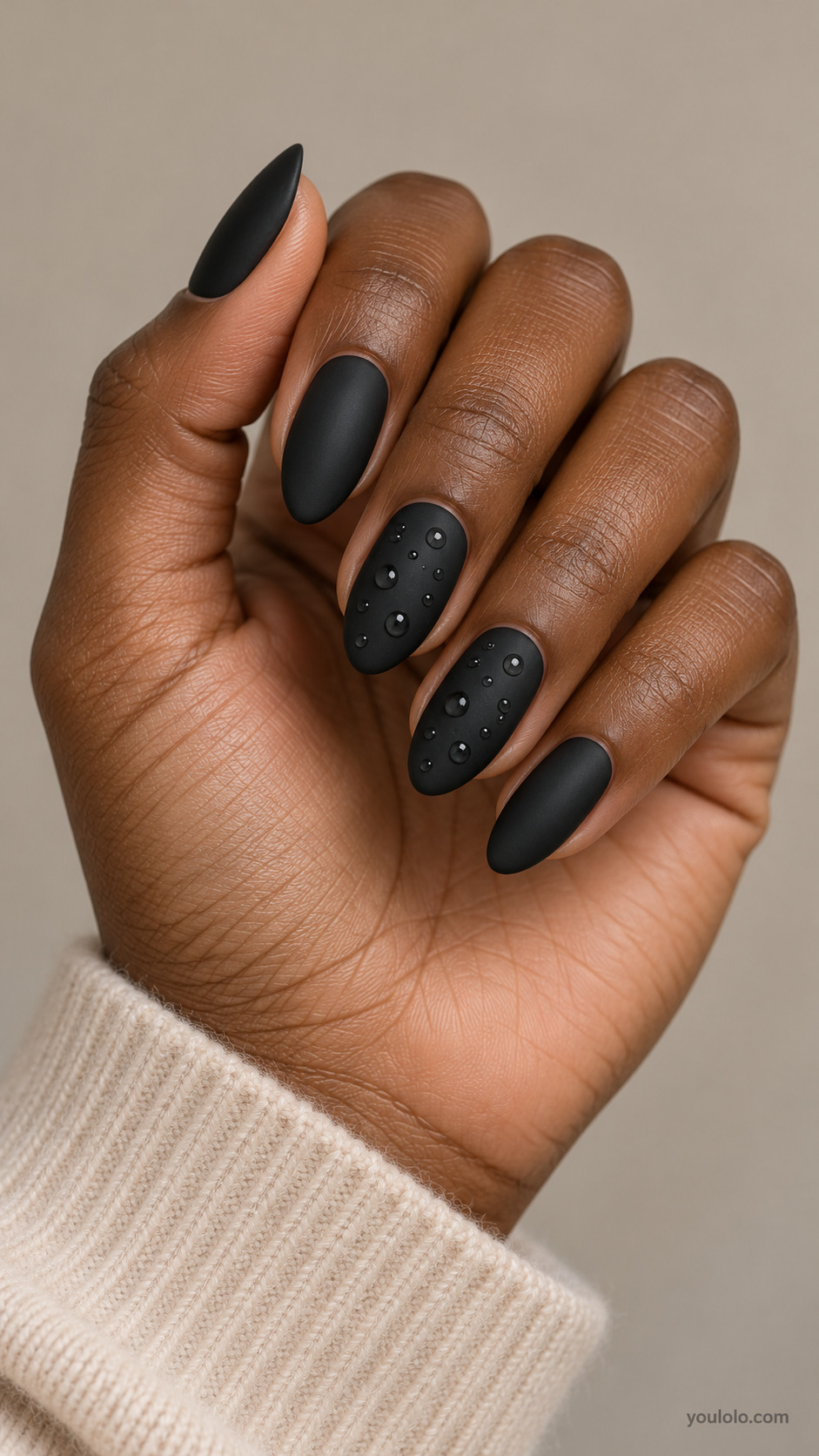 Matte black almond nails with small glossy raised droplets