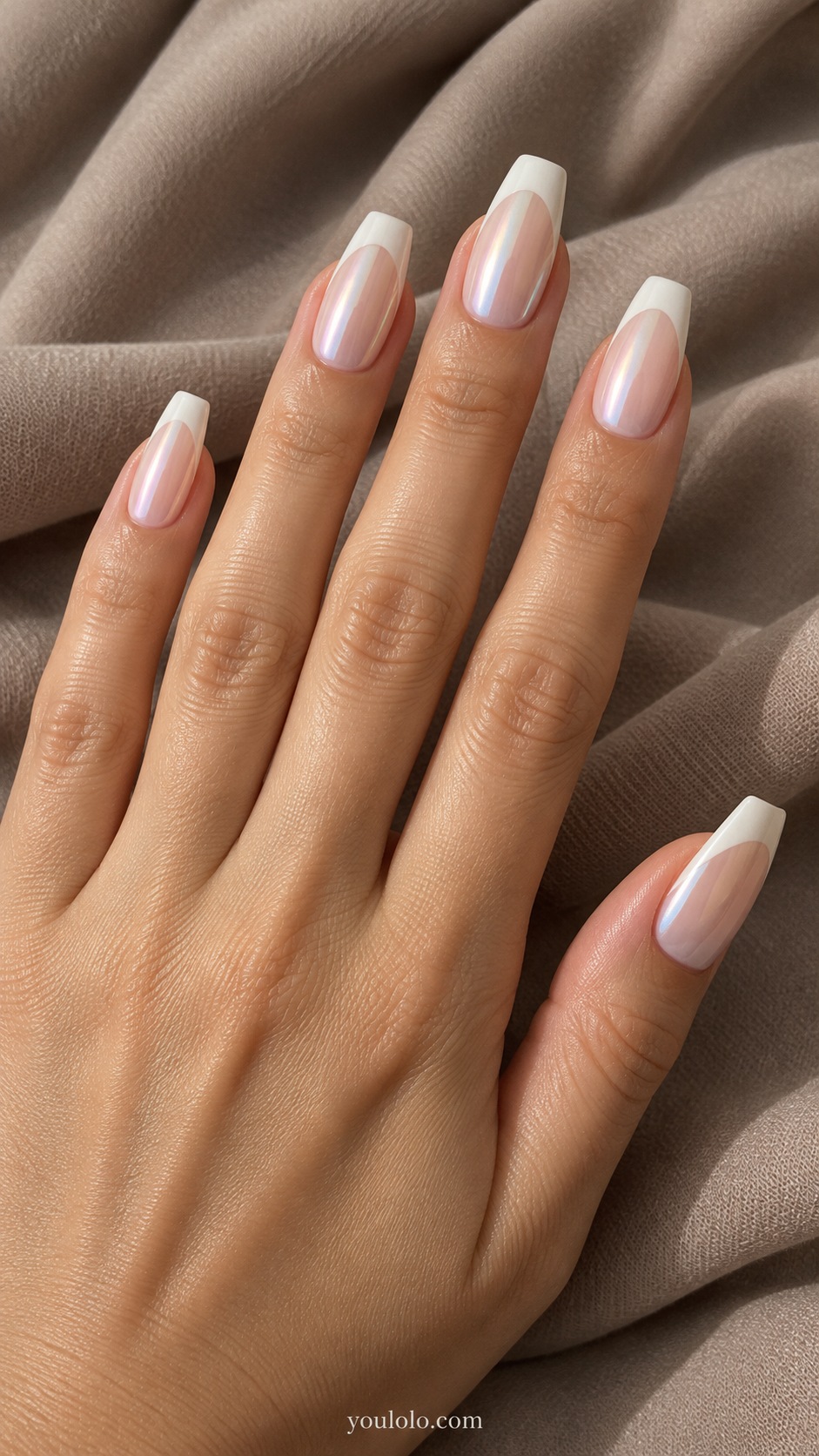 Medium coffin shaped nails fitted evenly and naturally, soft blush base with crisp opaque ivory French tips and fine pearl glaze over entire nail, no visible glue, no packaging