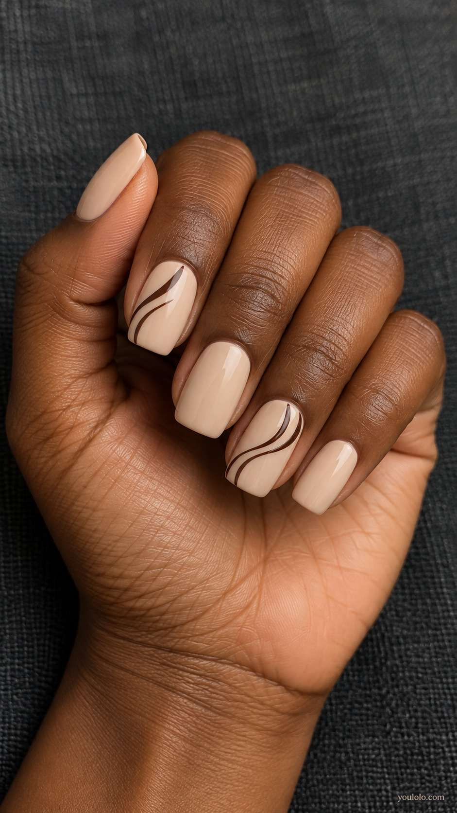 Cream square nails with thin chocolate brown swirls on two nails