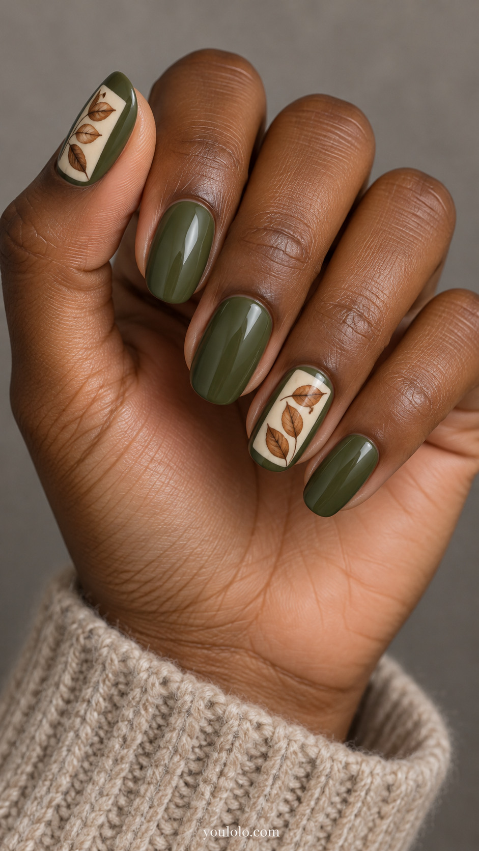 Medium round nails with olive green nails, ring and thumb feature small cream rectangular inset frames containing three individually painted brown beech leaves; other nails plain olive.