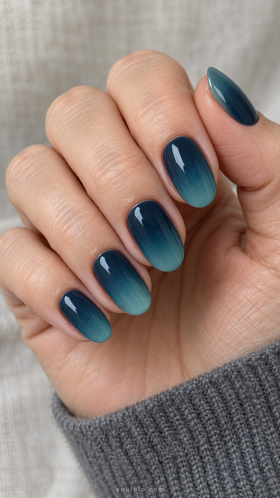 Petrol-blue oval nails gradually fading to muted teal tips