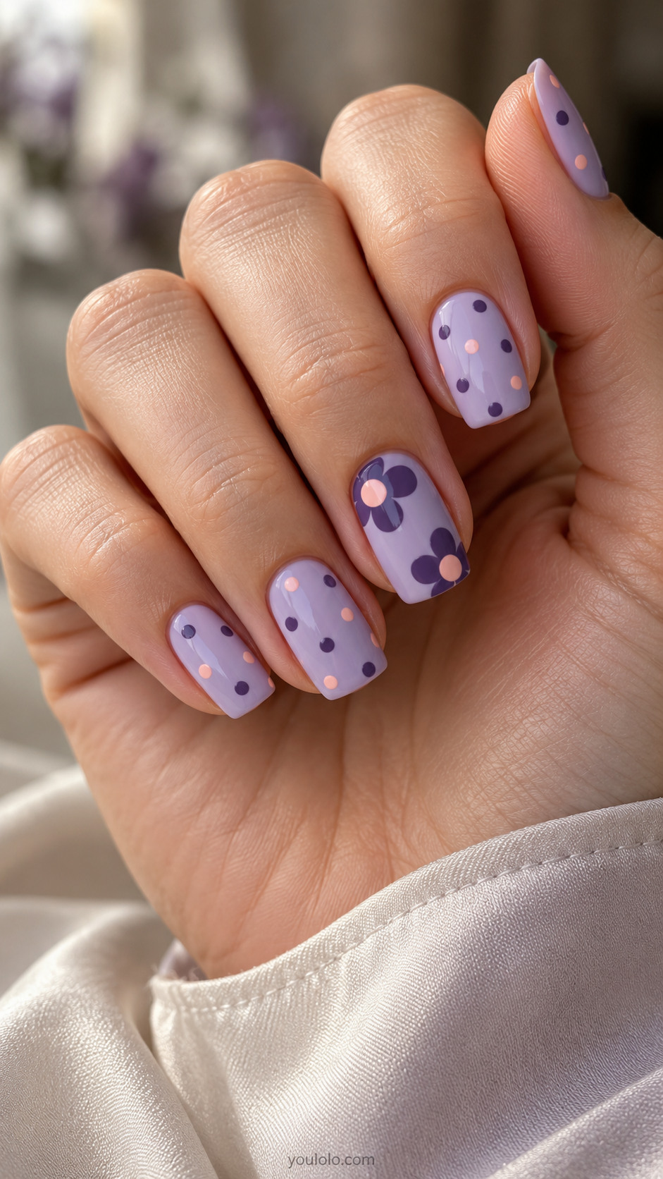 Soft square lavender nails with peach dots and oversized violet flower accents.