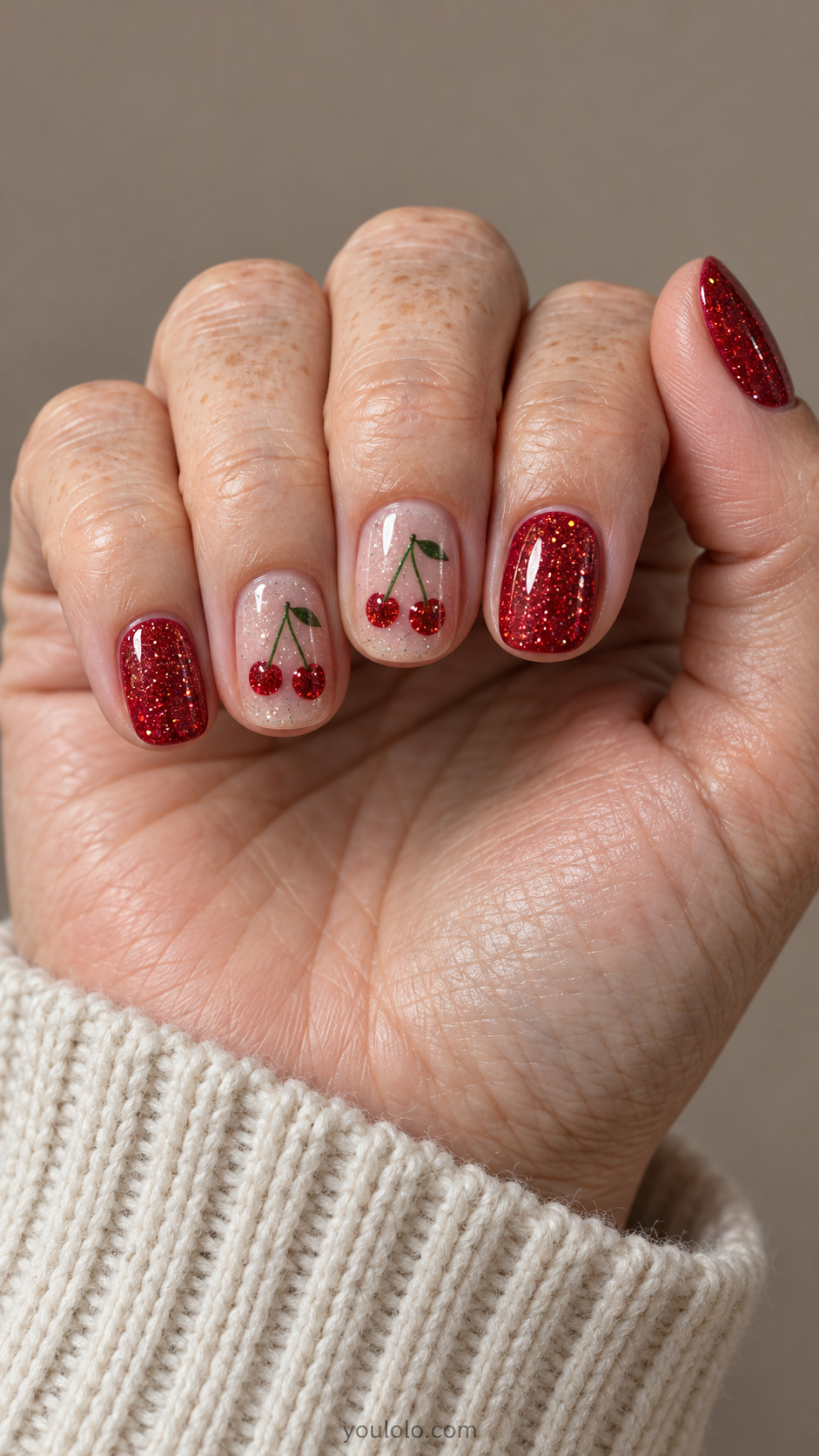 Short red nails with glitter cherry pairs on pale rose accents