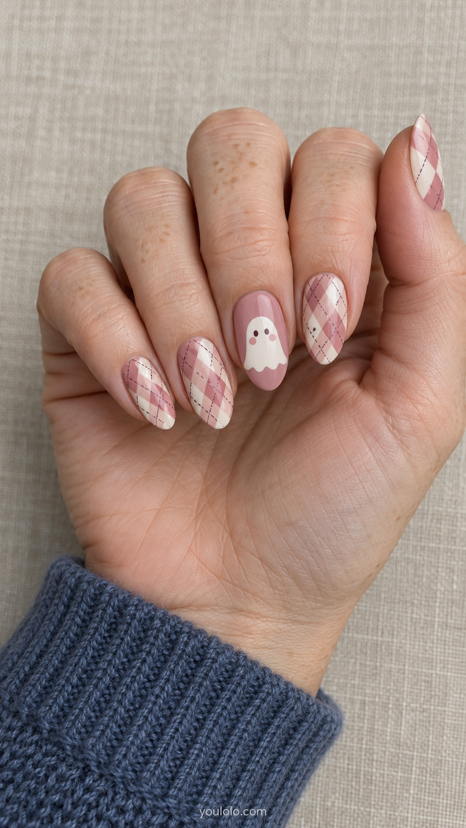 Pink almond nails with cream argyle diamonds and a ghost accent