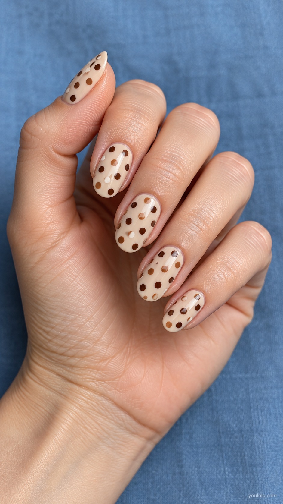 Three Brown Dot Mix — medium oval pale beige nails evenly spaced polka dots in three brown tones caramel cocoa espresso not irregular flecks
