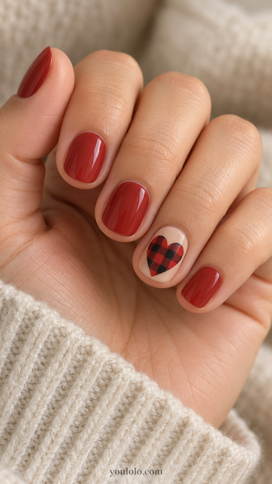 Muted-red round nails with a buffalo check heart on a nude accent nail