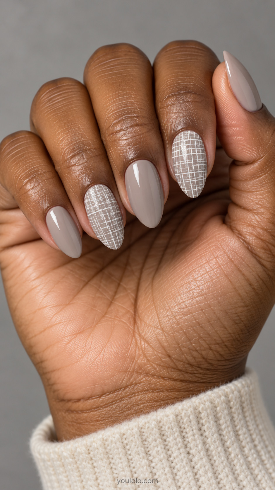 Cool greige nails with two accent nails covered in extremely fine irregular white crosshatch brush lines, flat texture no knit no shimmer.