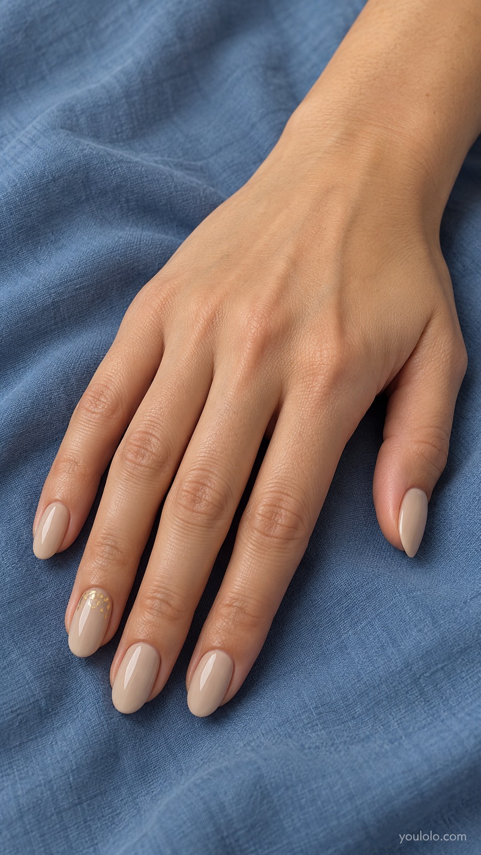 Latte Fine Gold Leaf — medium oval light latte cream nails tiny sparse flat gold foil pieces near base of ring nail only