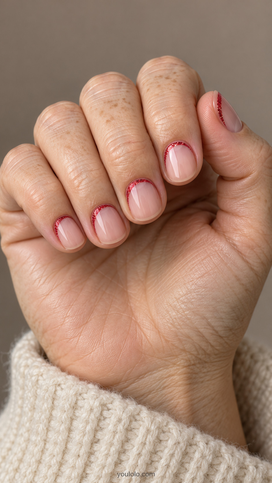 Nude round nails with offset red glitter cuticle crescents