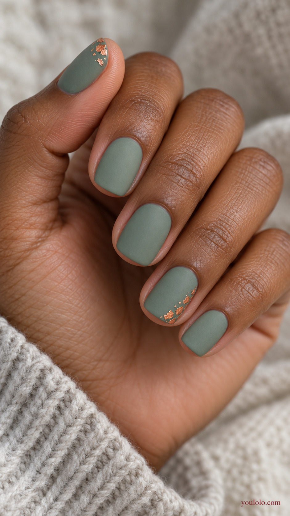 Sage with a Copper Foil Corner on a softly gathered feminine hand with a matte green manicure
