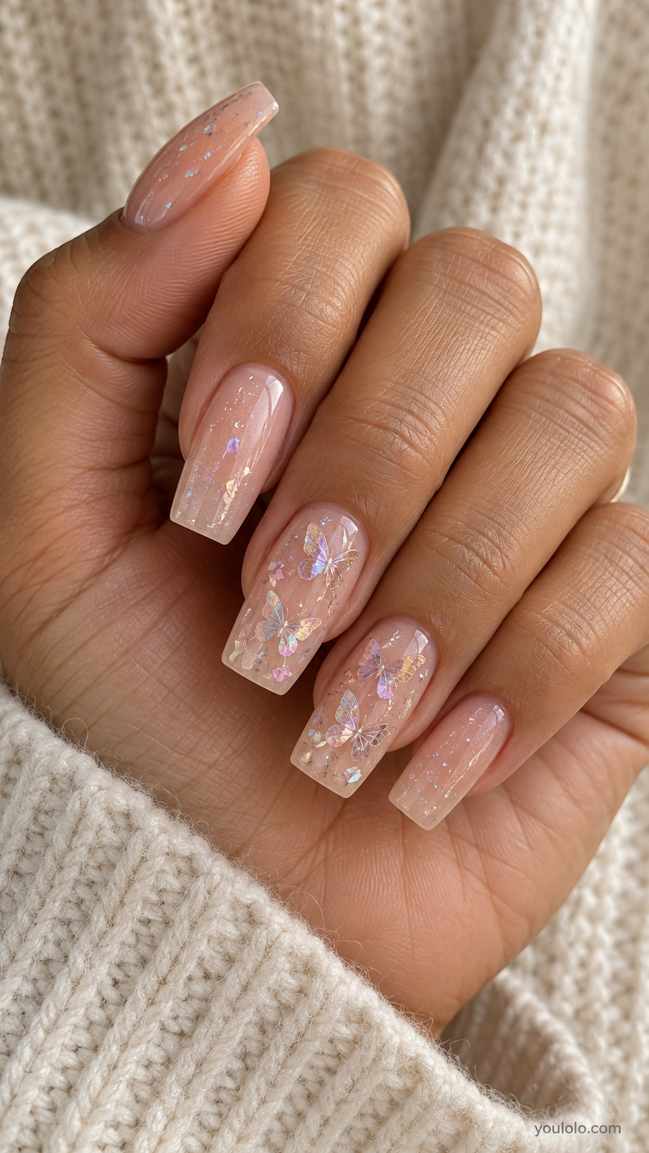 Long sheer pink square nails with iridescent butterfly accents and shimmer