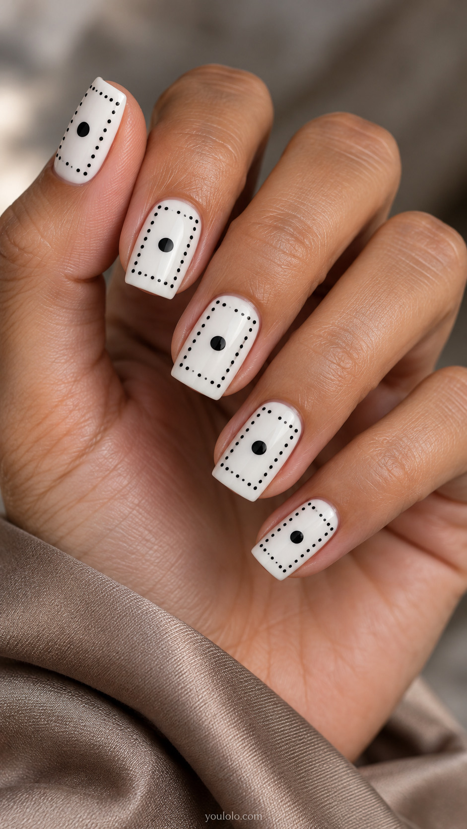 White square nails with fine black dotted borders and a single larger center spot