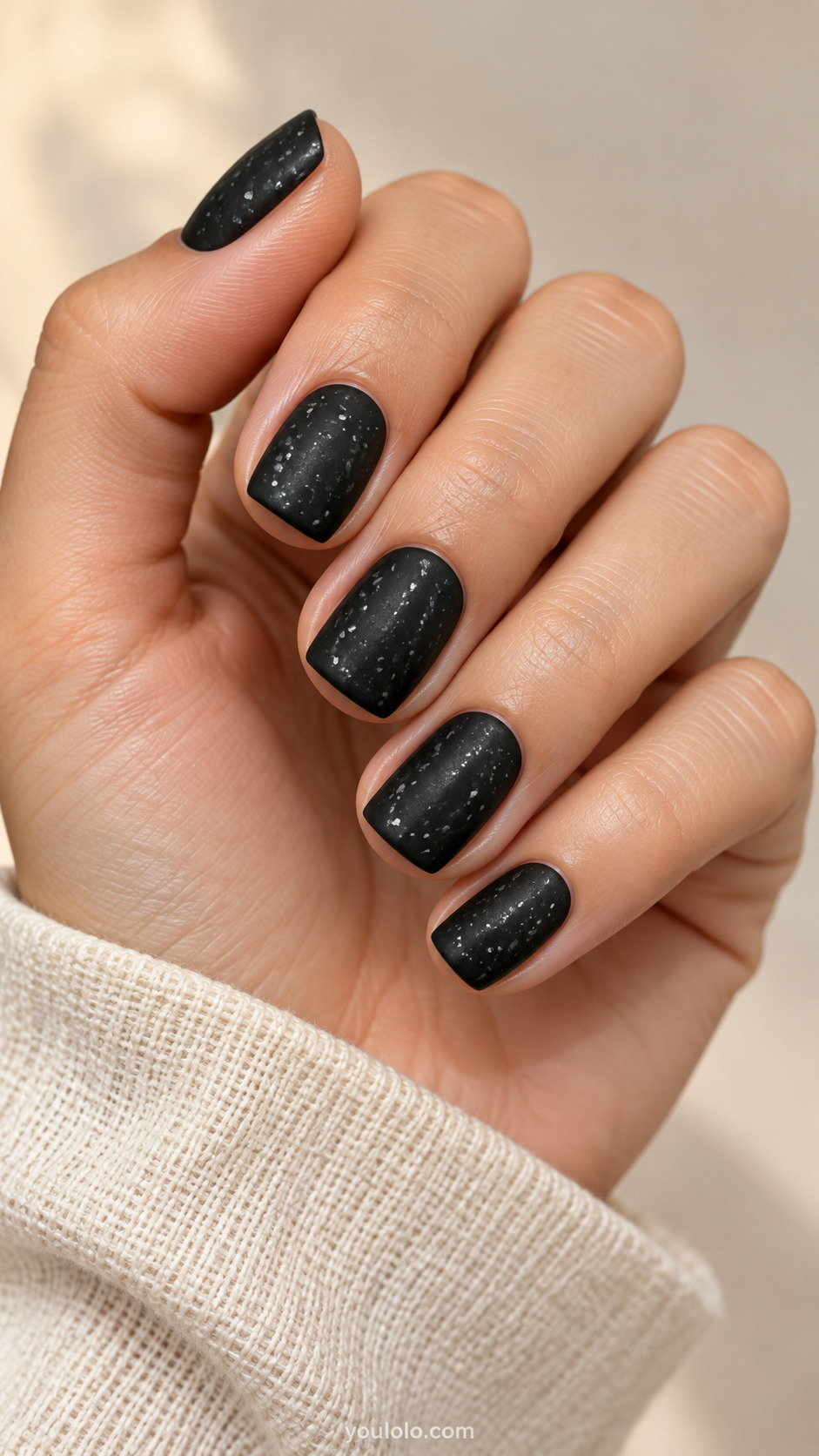 Matte charcoal square nails with sparse silver-gray speckles