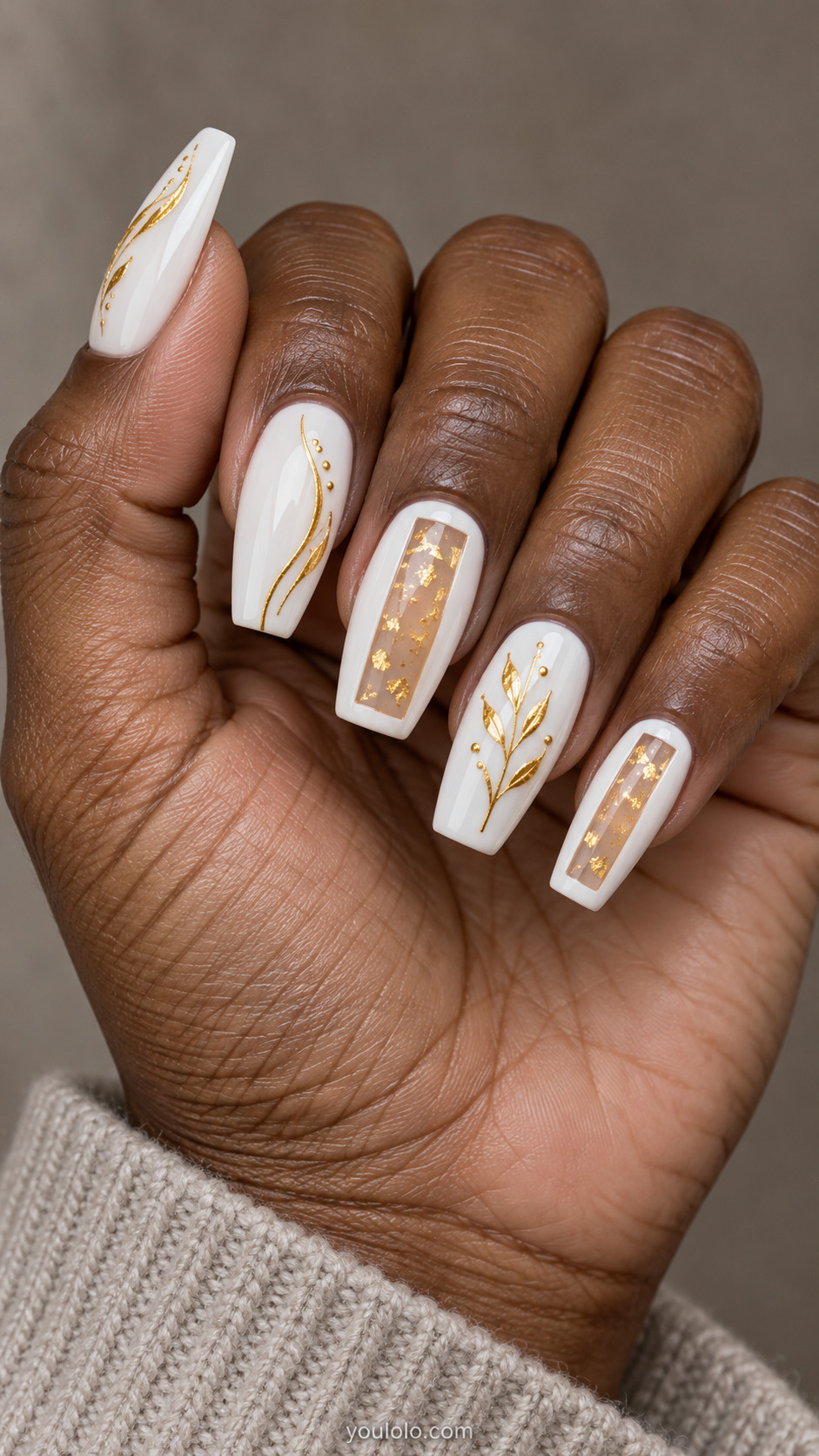 Long coffin white nails with translucent gold-foil windows on the middle and little nails, plus fine gold curves and a botanical accent on the remaining nails