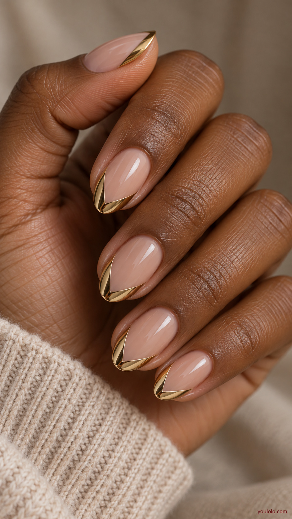 Golden V French Tips on a naturally gathered feminine hand showing the nail finish