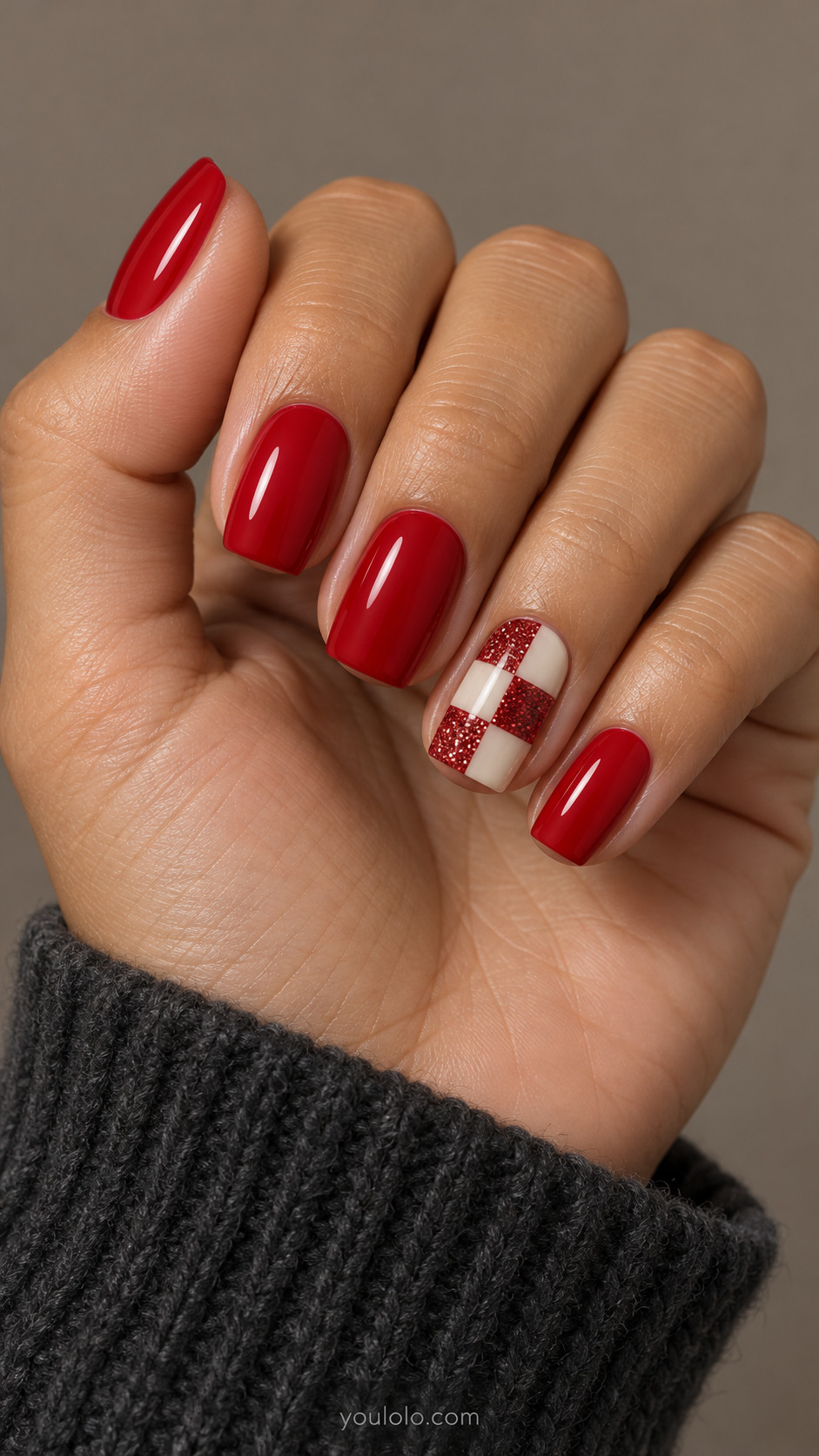 Red square nails with an ivory and glitter checker accent