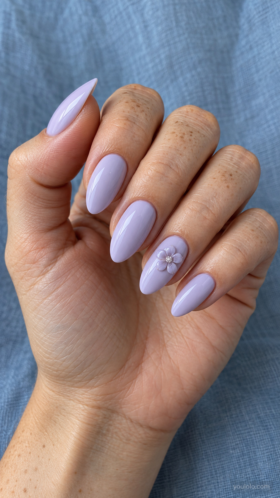 Long lilac almond nails with one raised lilac flower accent