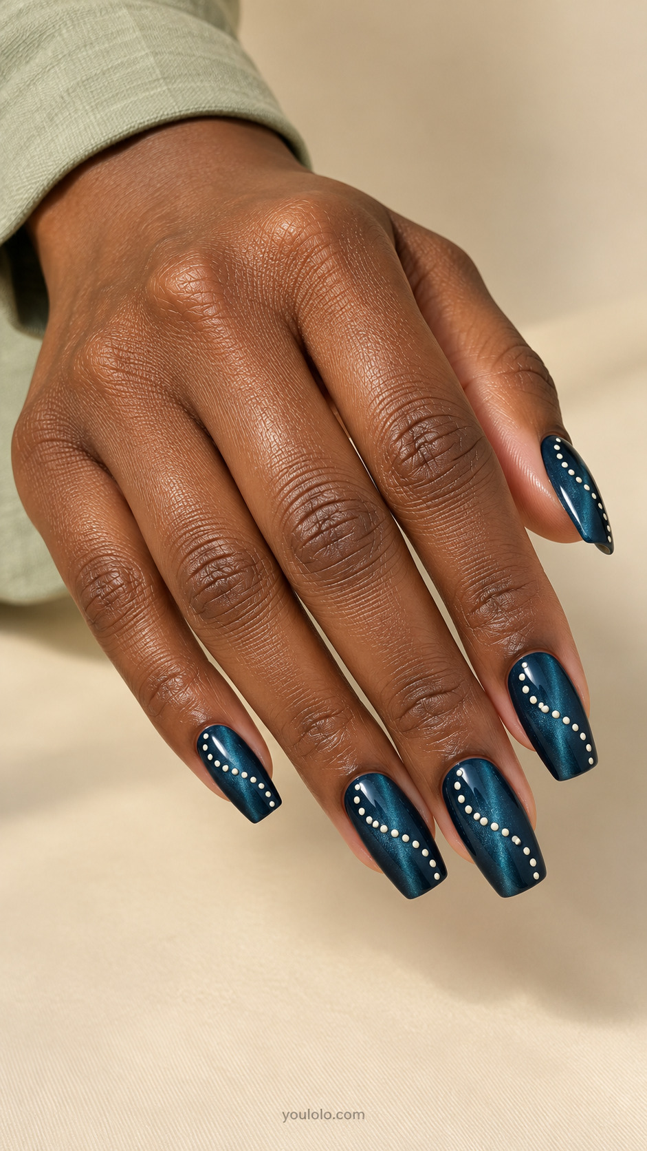 An Asymmetric Dotted S-Curve manicure on medium tapered square.