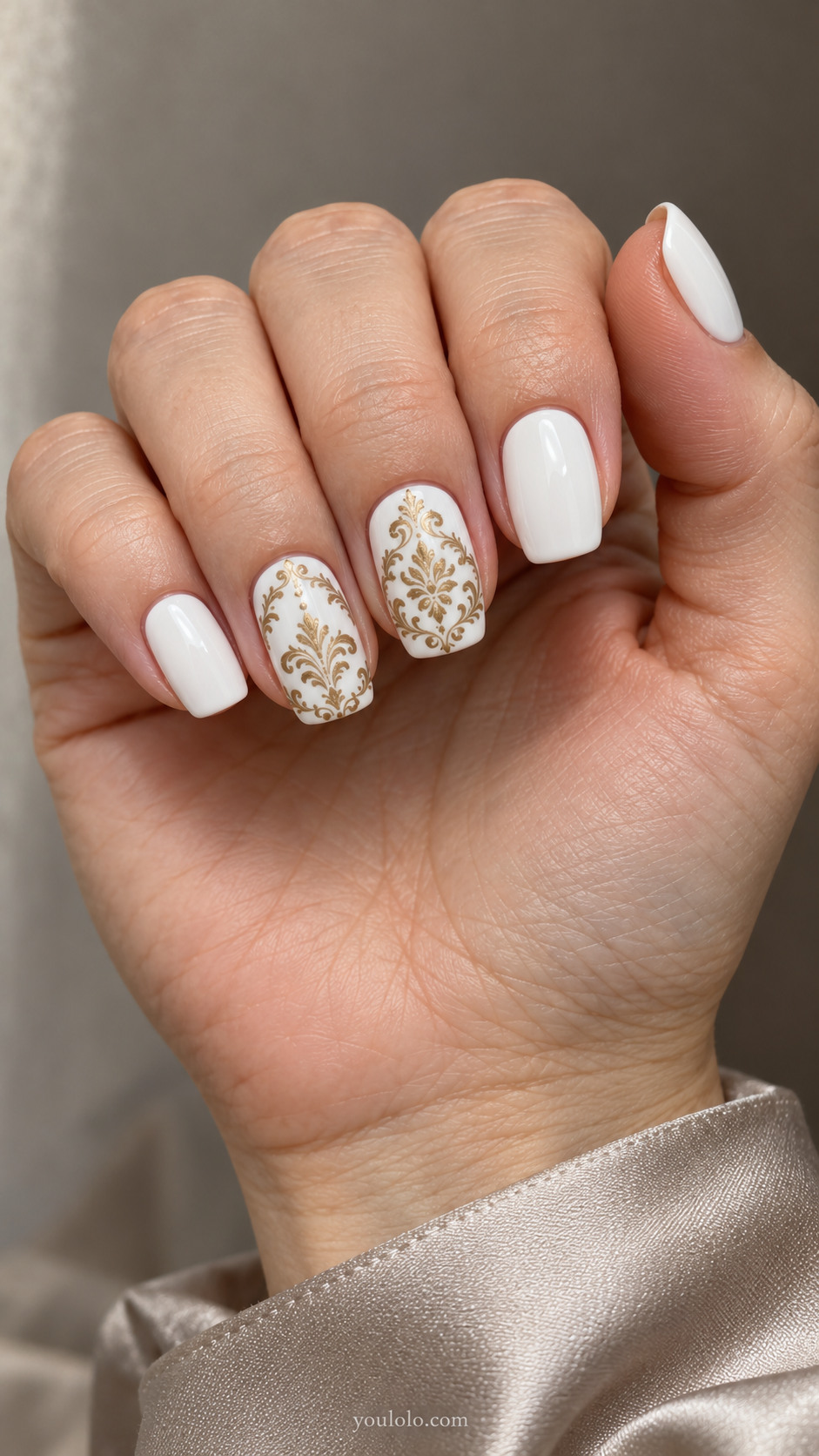 Medium squoval white nails with fine antique-gold damask medallions on two nails