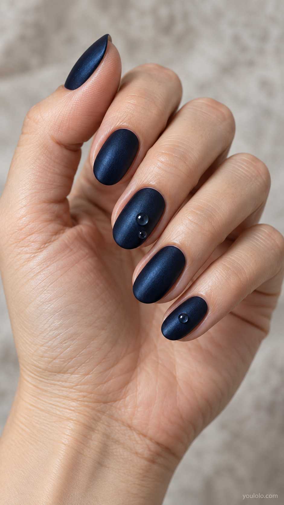 Blue Satin with Glossy Raindrops on a naturally posed hand, showing dark blue polish and detailed nail art