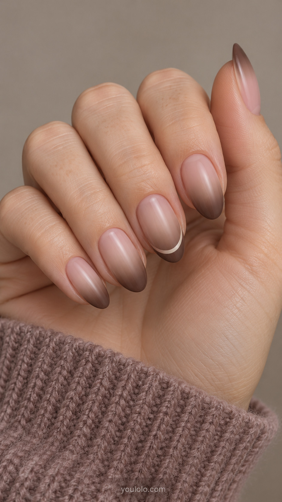 Nude-to-cocoa almond gradients with a narrow cream arc on one nail