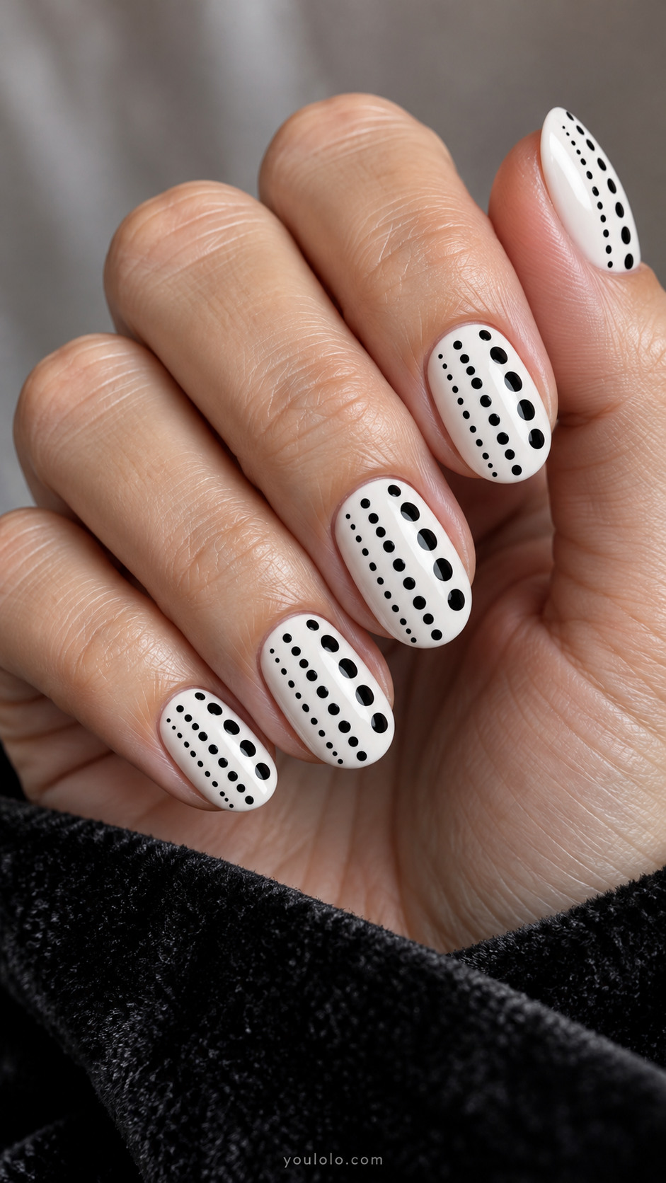 Medium oval white nails with three vertical lanes of black dots, left tiny densely spaced, center medium, right large sparsely spaced, all same deep black