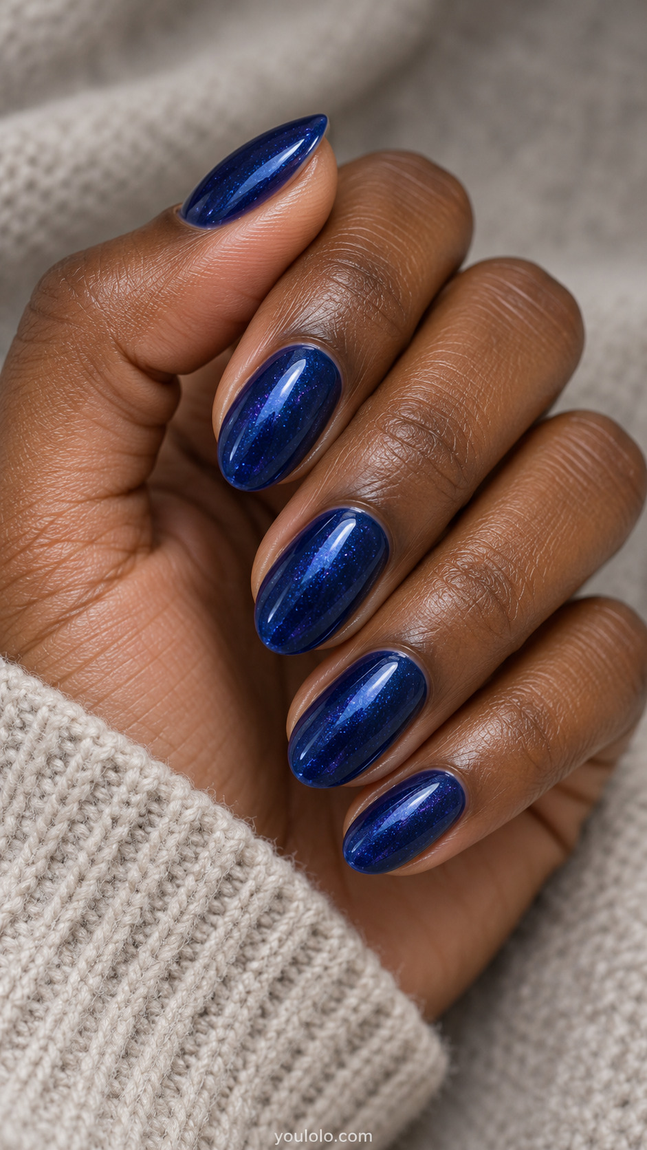 Sapphire Prism Shimmer on a softly gathered feminine hand with detailed sapphire blue manicure