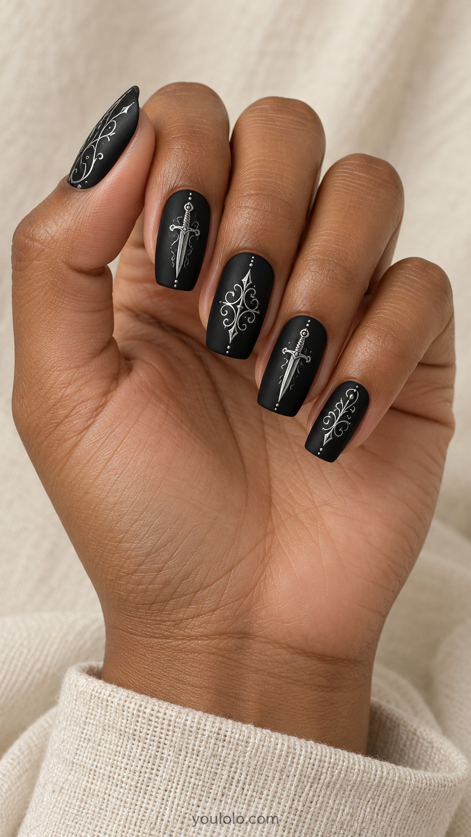 Medium square satin black nails extremely fine flat silver dagger drawings centered on two nails, delicate silver ornamental curls on others, gothic elegant