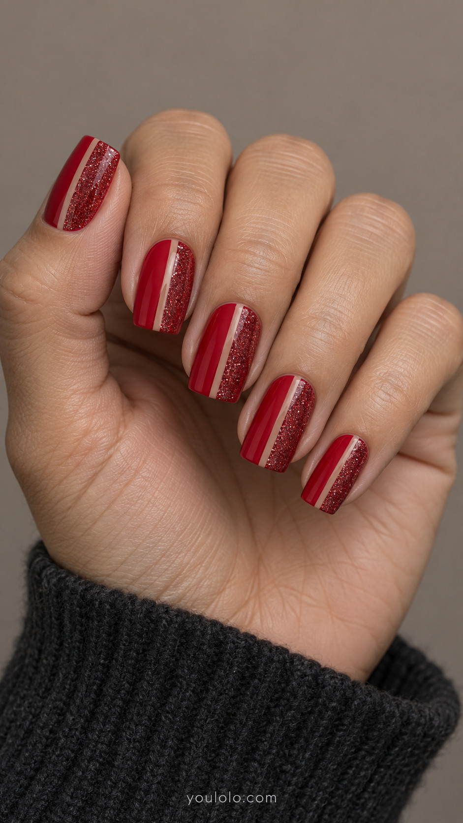 Square nails with red creme and glitter halves divided by nude channels
