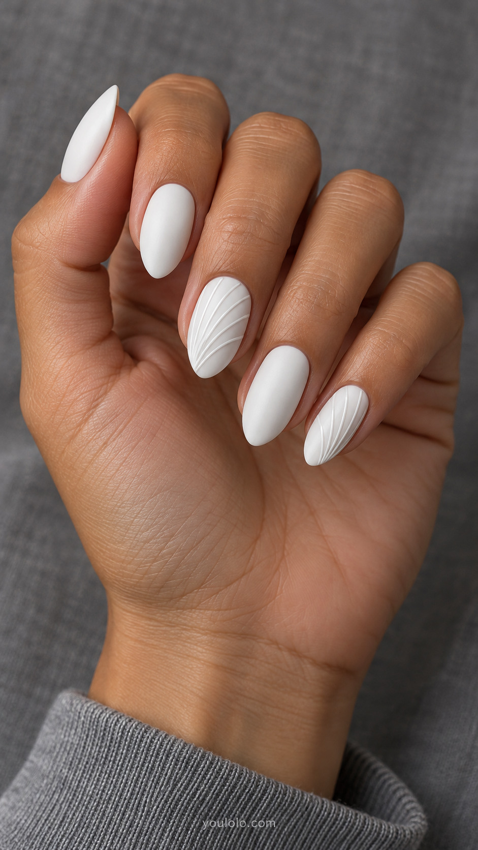 Matte white almond nails with shallow glossy fan ridges on two nails