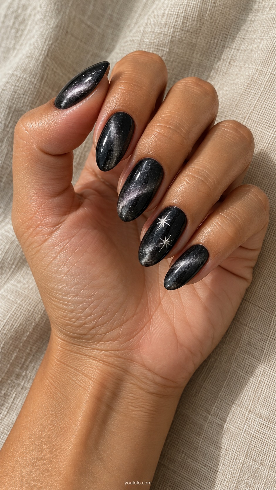 Black Cat Eye with Tiny Silver Stars cat eye nails — Medium almond black magnetic silver glow nails, ring nail two tiny hand painted silver stars.