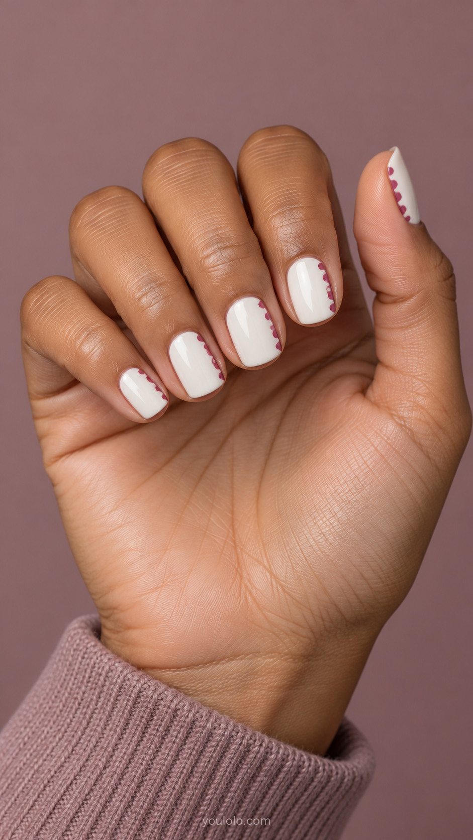 Short white squoval nails with muted raspberry scallops along one side
