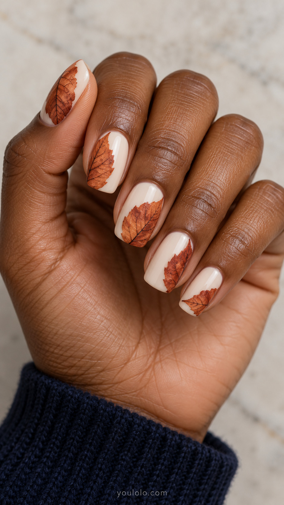 Medium squoval nails with milky ivory nails each with one large rust beech leaf half visible cropped along different side edges, very fine dark veins, all flat.