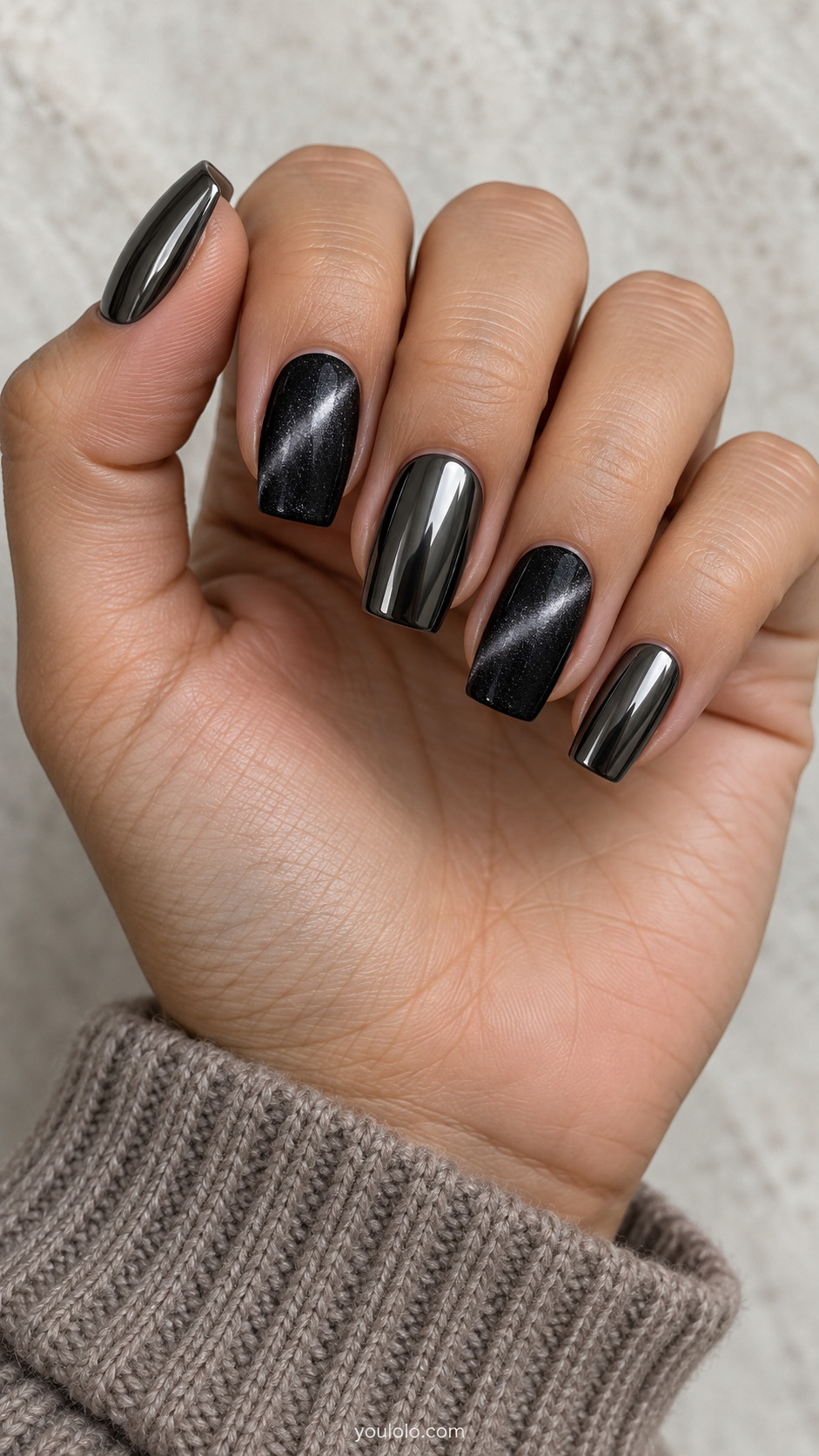 Medium tapered square coordinated set: thumb middle pinky dark gunmetal mirror chrome, index and ring charcoal black fine-particle cat-eye gel with one soft diagonal silver-grey magnetic band, no glitter chunks, finishes clearly different