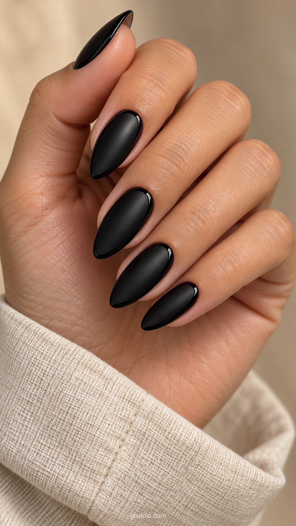 Satin black almond nails outlined with slim glossy black curves