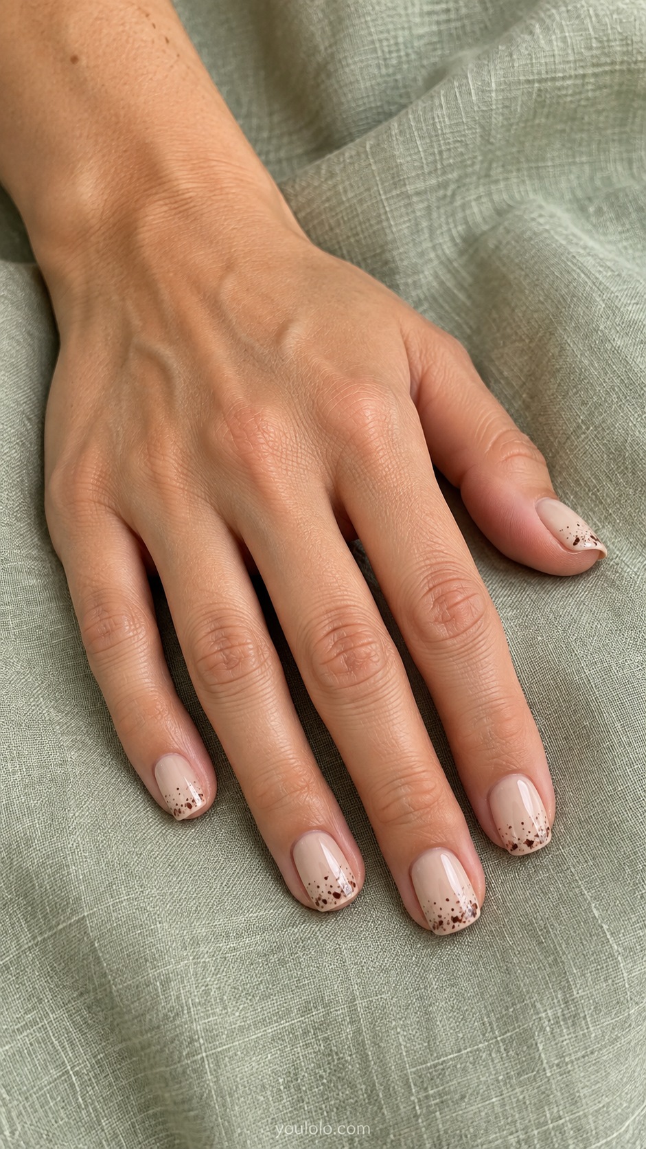 Hazelnut Speckle Edge — short squoval hazelnut cream nails tiny irregular espresso flecks concentrated only at free edge no regular polka dots
