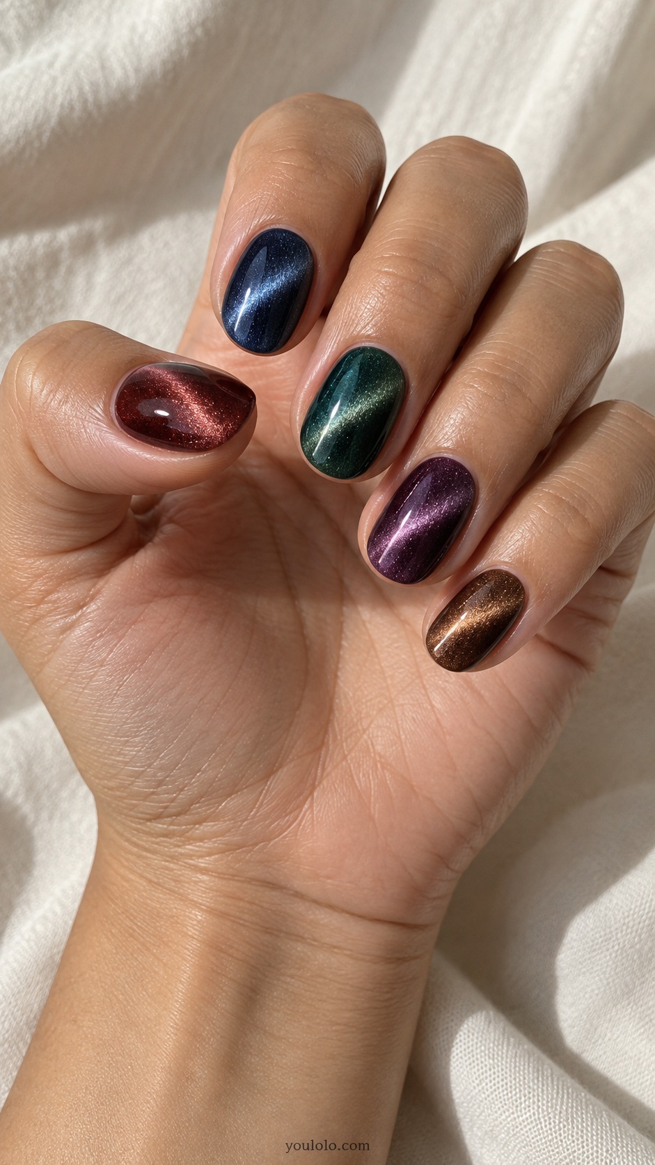 Jewel-Tone Cat Eye Skittle cat eye nails — Short oval magnetic cat eye set, thumb garnet, index sapphire, middle emerald, ring plum, little bronze, soft matching bright beams.